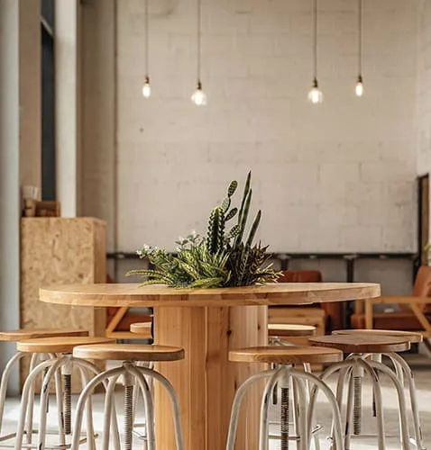Popular color dining chairs and wood top tables are preferable choices that feel highlight of café design the best.